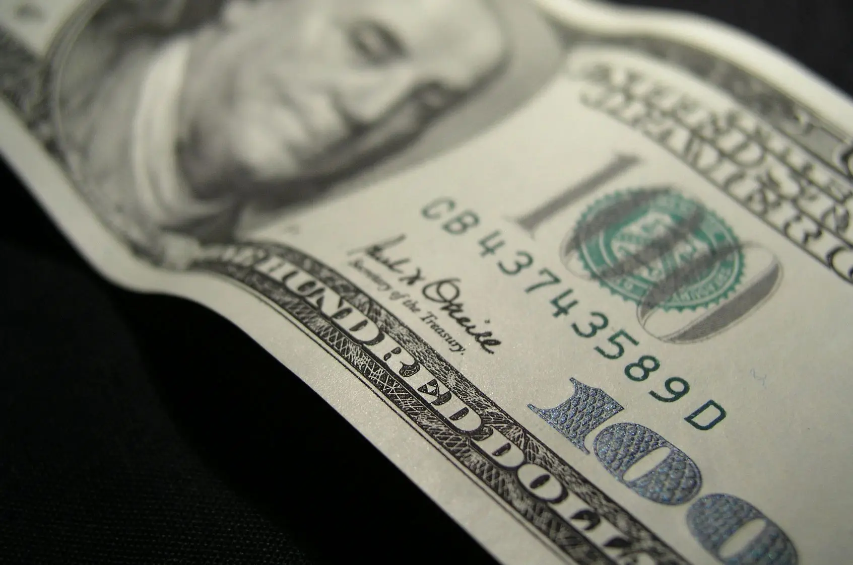 Hundred dollar bill on dark background